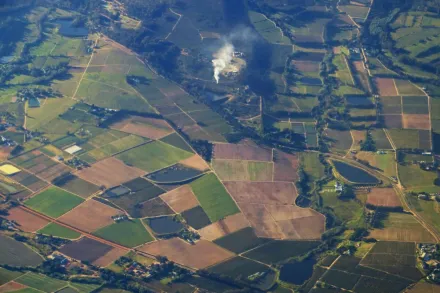 Aerial landscape of diverse farmlands and countryside near Cape Town, showcasing agricultural patterns.
