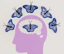 Creative illustration of butterflies representing thoughts over a brain silhouette.