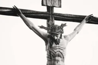Monochrome depiction of Jesus crucified, showcasing religious artistry and sacrifice.