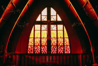 A stunning church interior with vibrant stained glass windows and wooden pews.