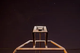 A low angle shot of a basketball hoop against a starry night sky.