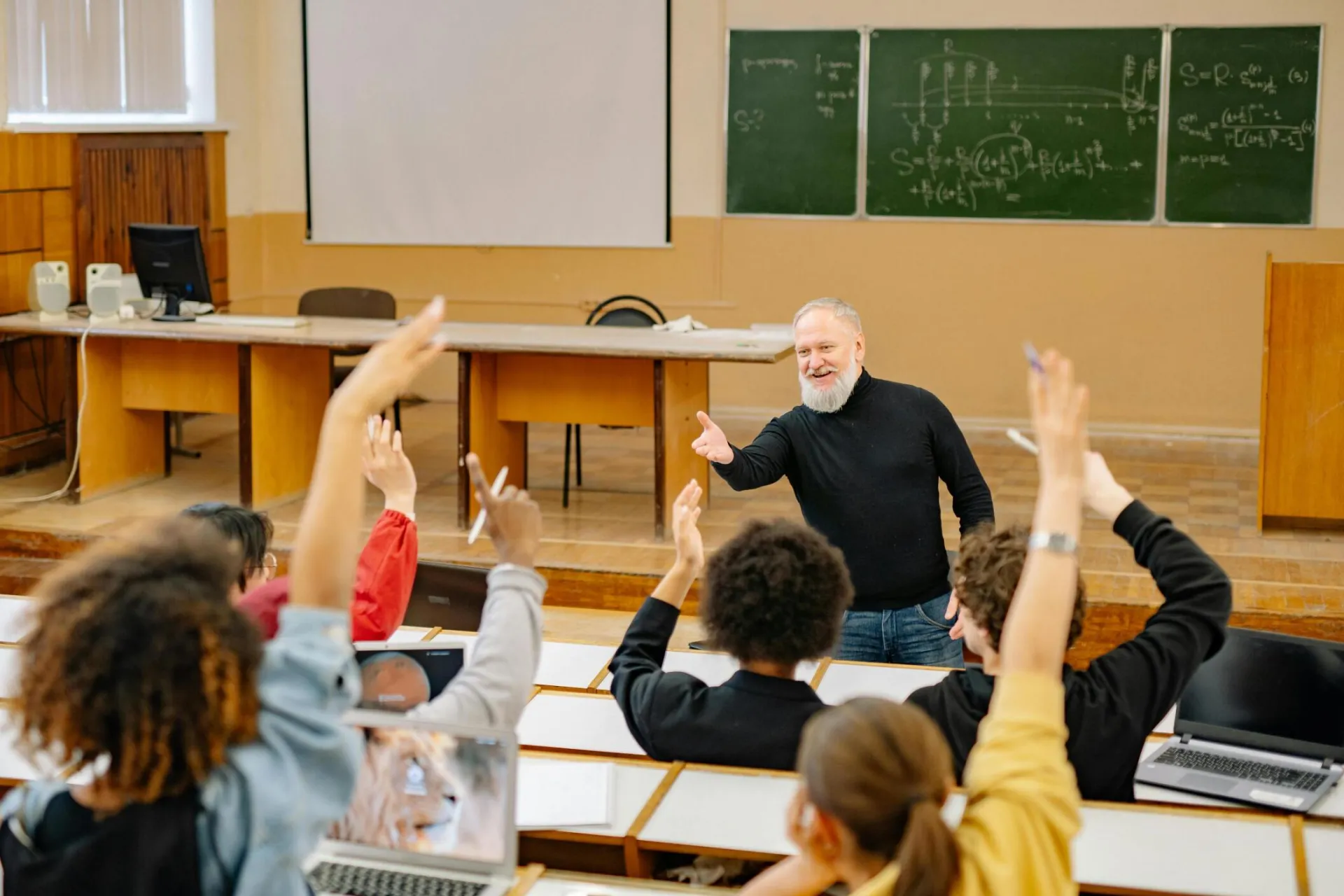 A teacher  interacting in a classroom discussing the services offered at the Pop In Concierge