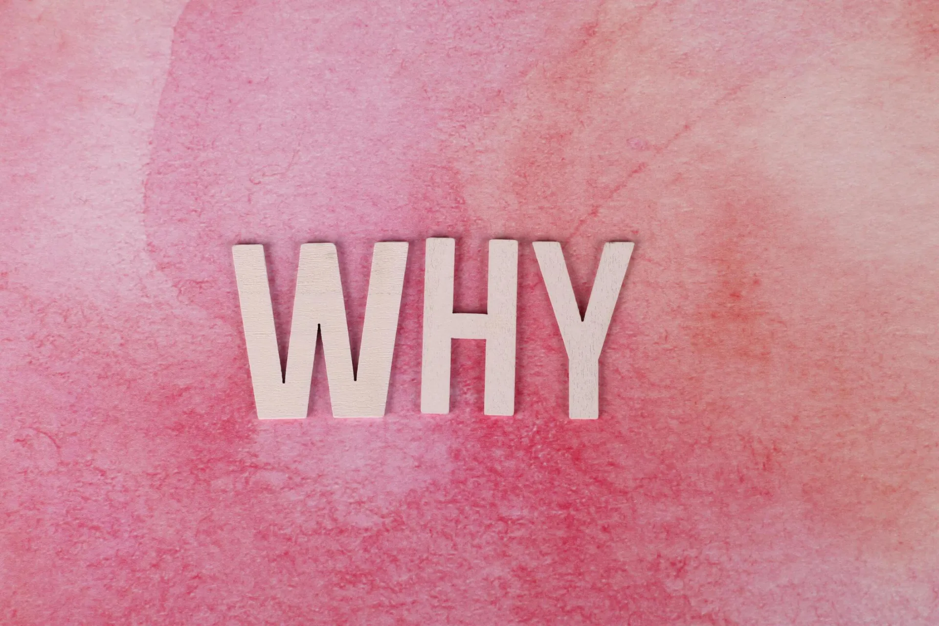 Bold white letters spelling WHY on a pink textured background for using the Pop In Concierge Service