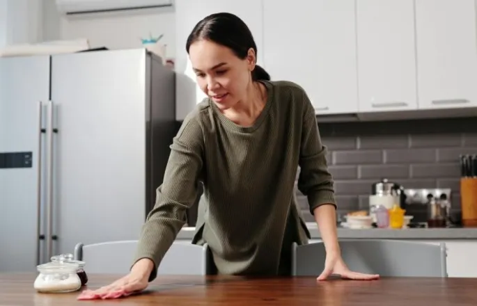 A supportive moment indoors featuring a Pop In Concierge helping tyding up the home