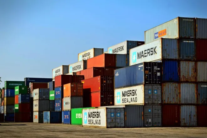 Colorful stacked shipping containers at a port exemplify global logistics.