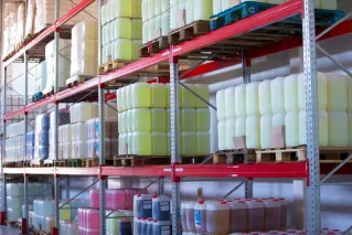 Spacious warehouse aisles lined with shelves stacked with boxes and packaging.
