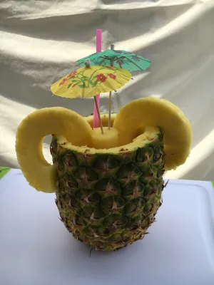 Hands adding syrup to shaved ice desserts creating vibrant treats.