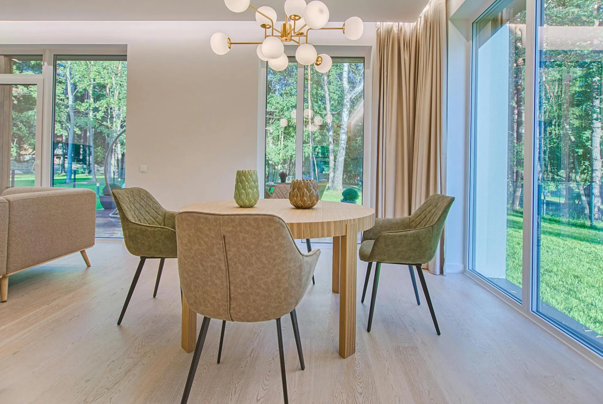 Elegant dining room featuring modern furniture and large windows for natural light.