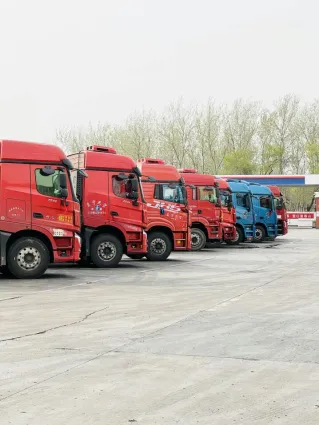 A row of vibrant trucks parked at a transportation depot in Tianjin, China.