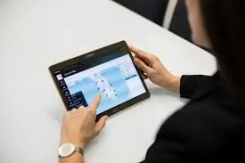 An individual operating a digital smartwatch displaying time with a blue interface.