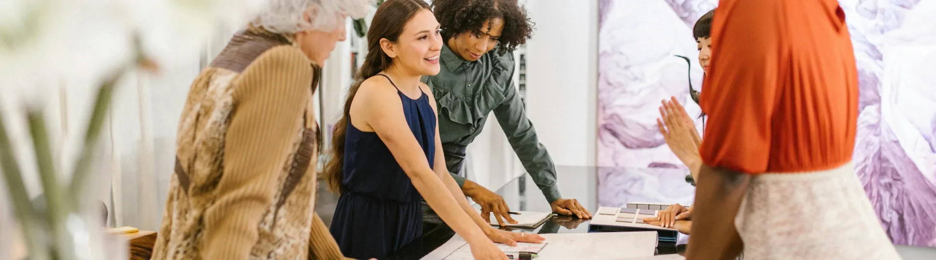 A diverse group of businesswomen discussing ideas together in a modern office setting.
Teamwork, Collaboration, Question