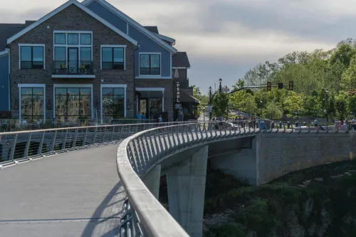 Explore the scenic pedestrian bridge in Dublin, Ohio, showcasing modern architecture and lush surroundings.