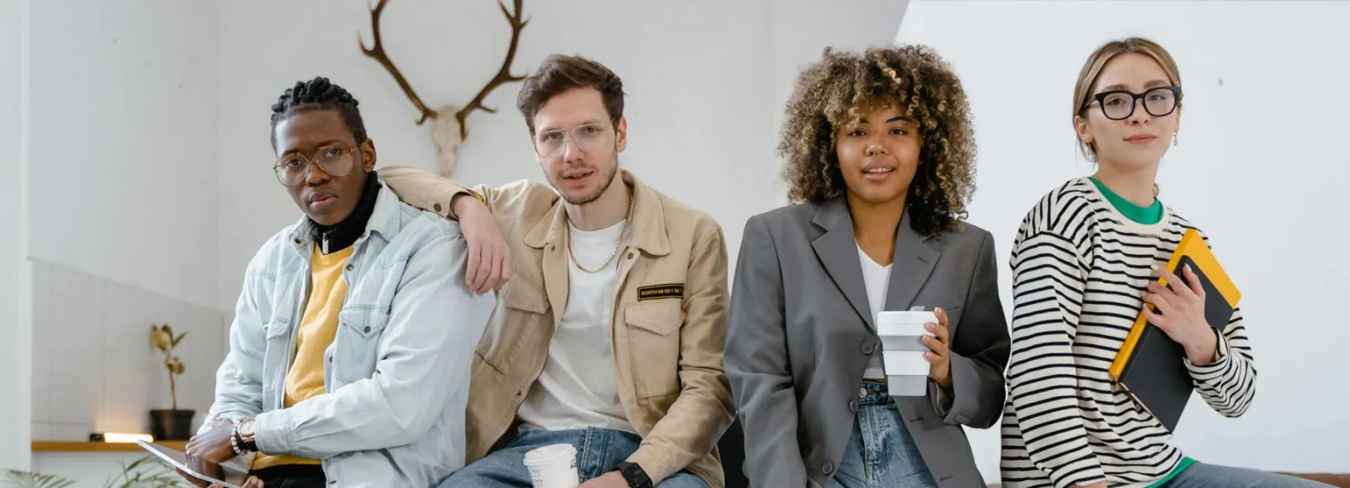 A multicultural group of young professionals in a modern office setting, showcasing teamwork and creativity.