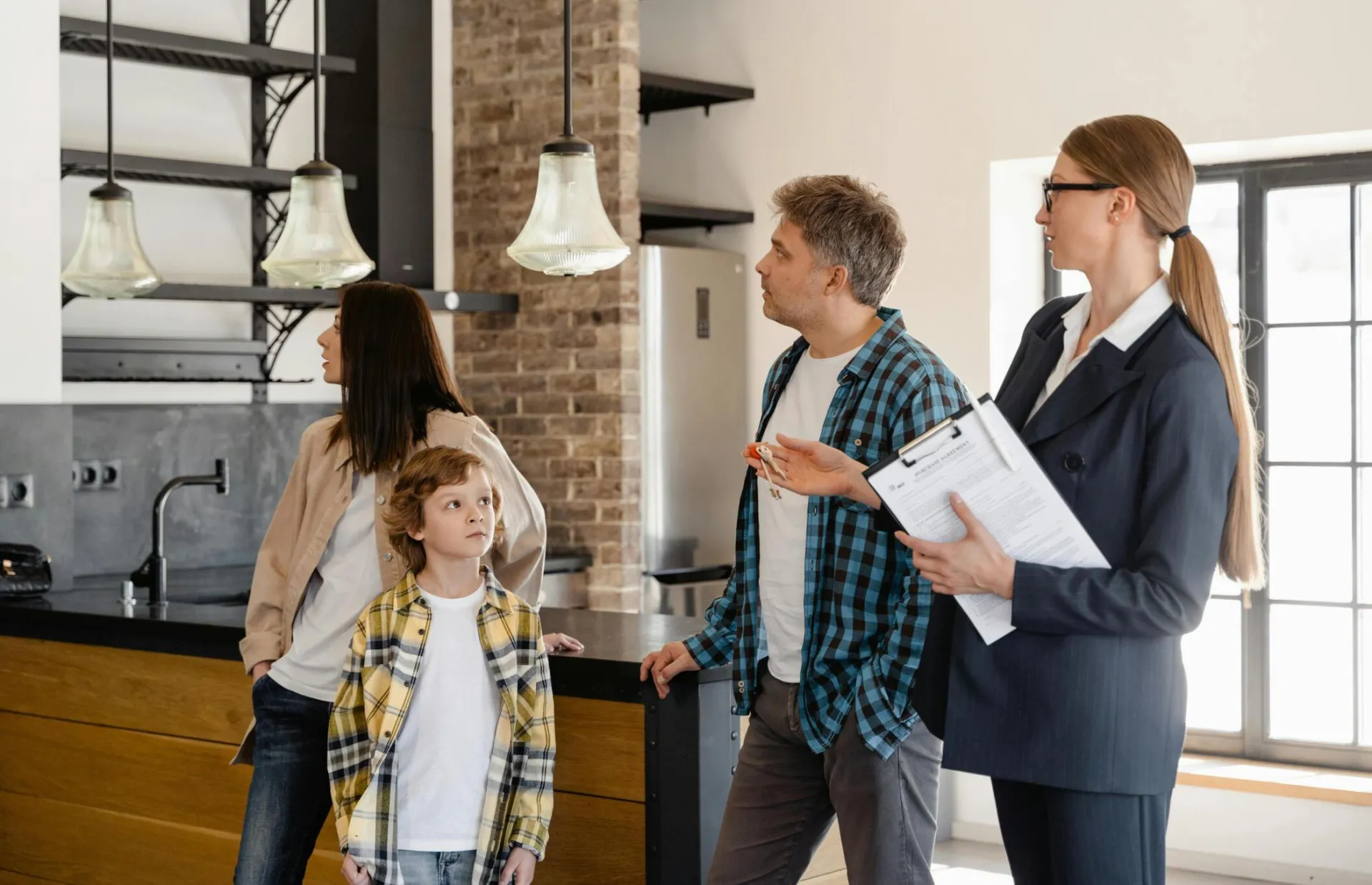 A family converses with a real estate agent about a modern home interior.