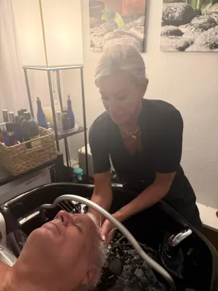 Relaxing spa treatment with facial and sponge massage in a serene environment.