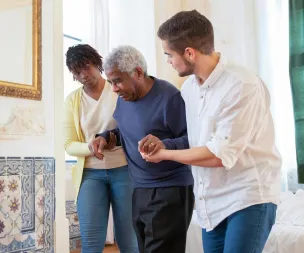 Elderly man receiving assistance in a beautiful room with traditional Portuguese tiles.