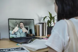 A student engaged in an interactive online class via video conference.