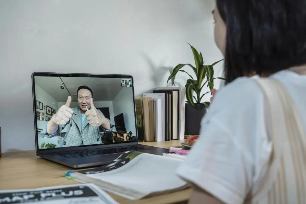 A student engaged in an interactive online class via video conference.