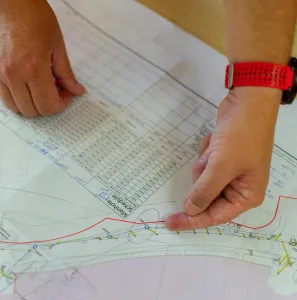 Hands pointing at architecture blueprint for construction planning.