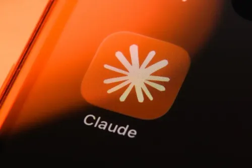 A smartphone home screen with the Claude app icon and logo visible with an orange gradient and shadow covering one side