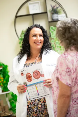 Speech-language pathologist explains swallowing anatomy to a patient