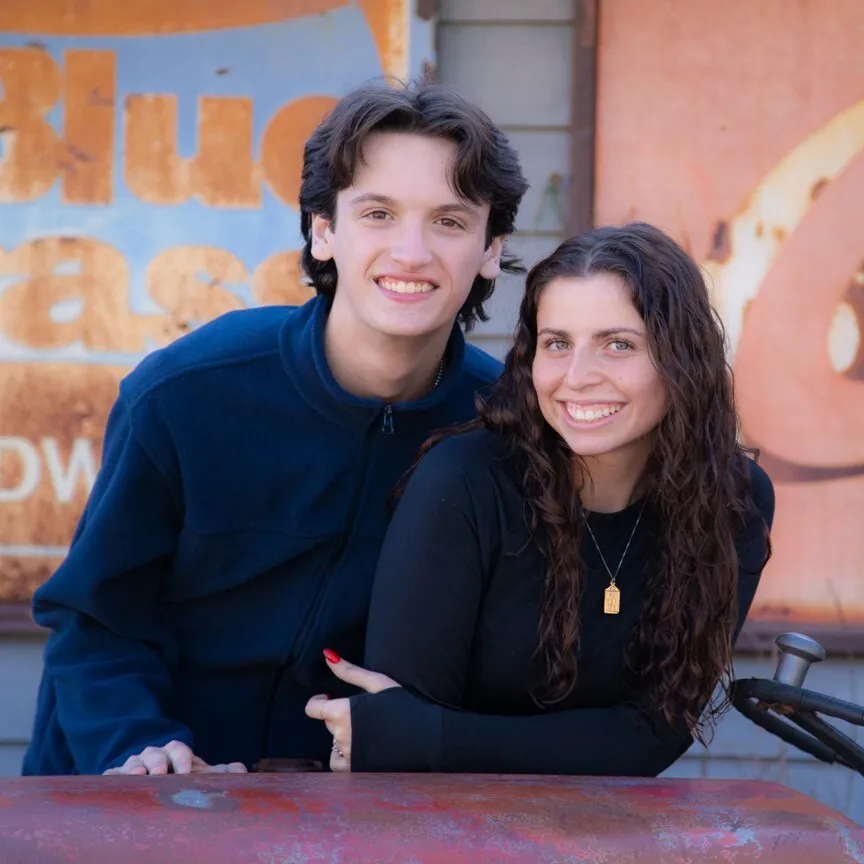 young couple smiling and posing for a photo
