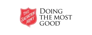 Volunteers preparing food packs indoors for donation.