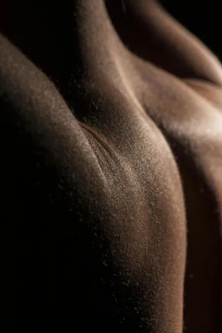 A captivating close-up image showcasing skin texture with elegant lighting, creating a dramatic effect.
