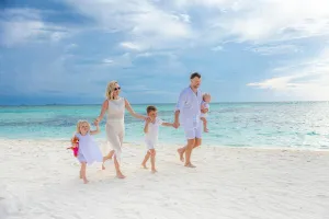 Happy family running at the beach