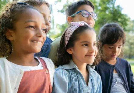 Cheerful group of diverse children enjoying a day outdoors in Portugal.