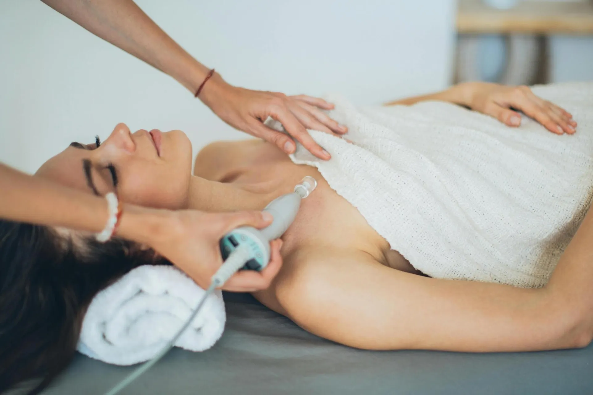 Woman receiving a laser spa treatment focused on relaxation and wellness.