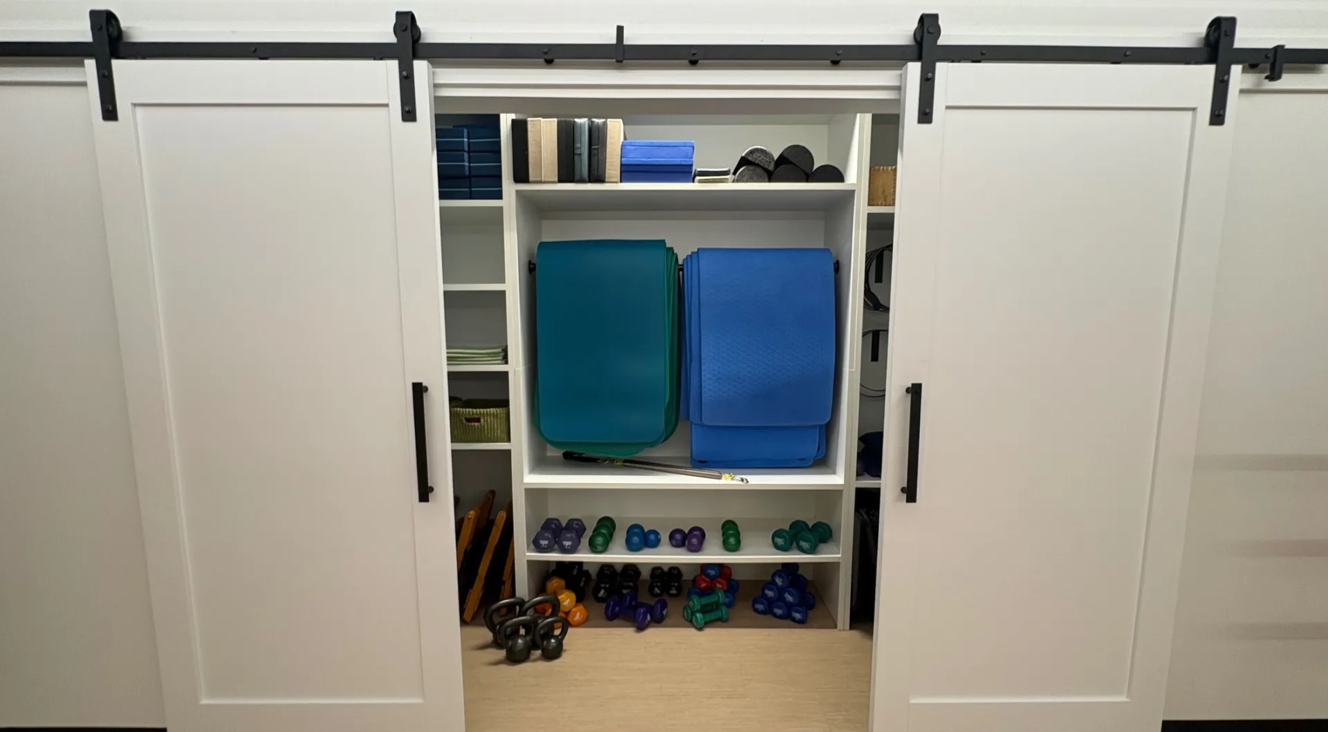 Spacious wooden closet with mirror reflecting modern minimalist style, perfect for home interior design.