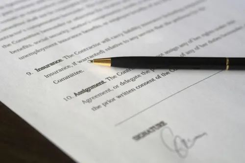 Close-up image of a business contract and pen, signed and ready for agreement.