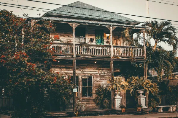 Explore a rustic vintage wooden house surrounded by tropical foliage in Key West, FL.