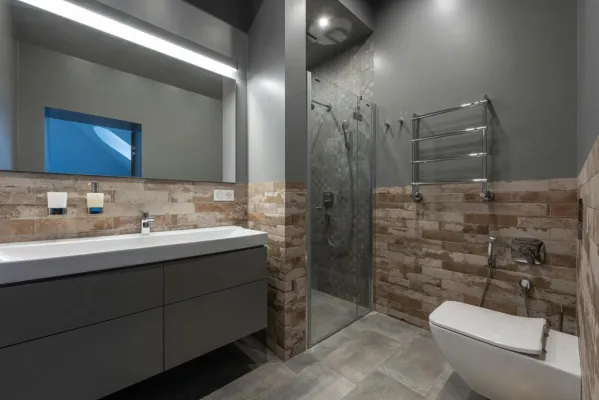 Sleek modern bathroom featuring a glass shower, floating vanity, and stylish decor.