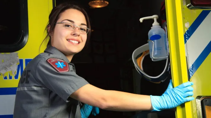 Two paramedics standing by an ambulance, showcasing readiness for emergency response.