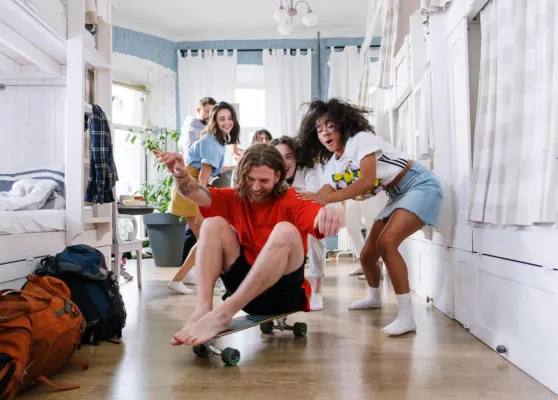 A group of friends enjoying playful moments indoors, showcasing youthful spirit and camaraderie.