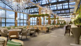 Elegant restaurant interior in Baghdad featuring chandeliers and a view.