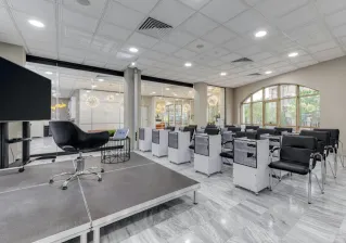 Spacious conference room with podium, chairs, and glass partitions featuring modern design elements.