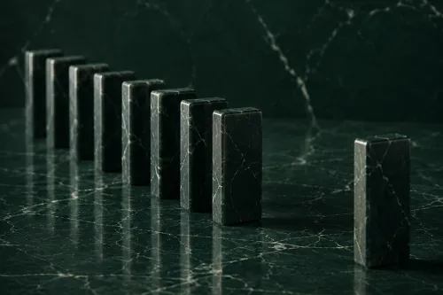 Marble dominos representing businesses falling behind when operational knowledge is undocumented