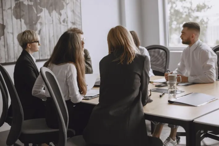 Colleagues meeting in a modern office, representing middle managers translating leadership priorities into execution.