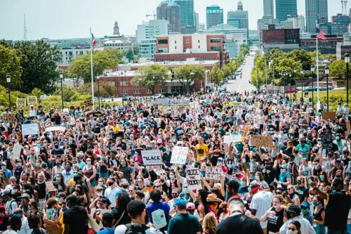 Large crowd gathering for Black Lives Matter protest in Des Moines city center, advocating for social justice.