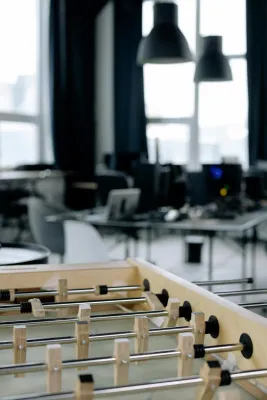 Creative workspace with foosball table in modern startup office setting