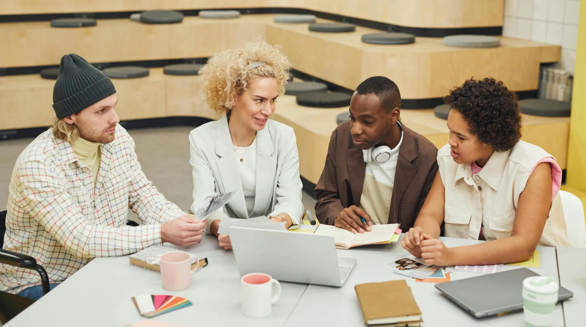 A diverse group of coworkers engaged in a brainstorming session in a modern office setting.