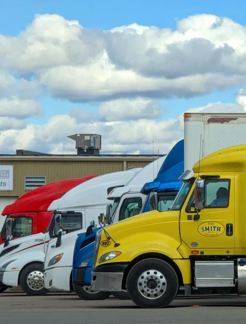A vibrant lineup of semi trucks parked outside a Nova Truck Center in Truro, NS, Canada.