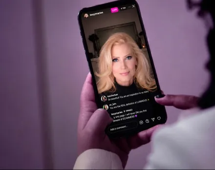 Close-up of an adult using a smartphone with a blank screen indoors, ideal for tech and lifestyle themes.