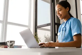 A cheerful female doctor holding a clipboard and medicine, conveying professionalism.