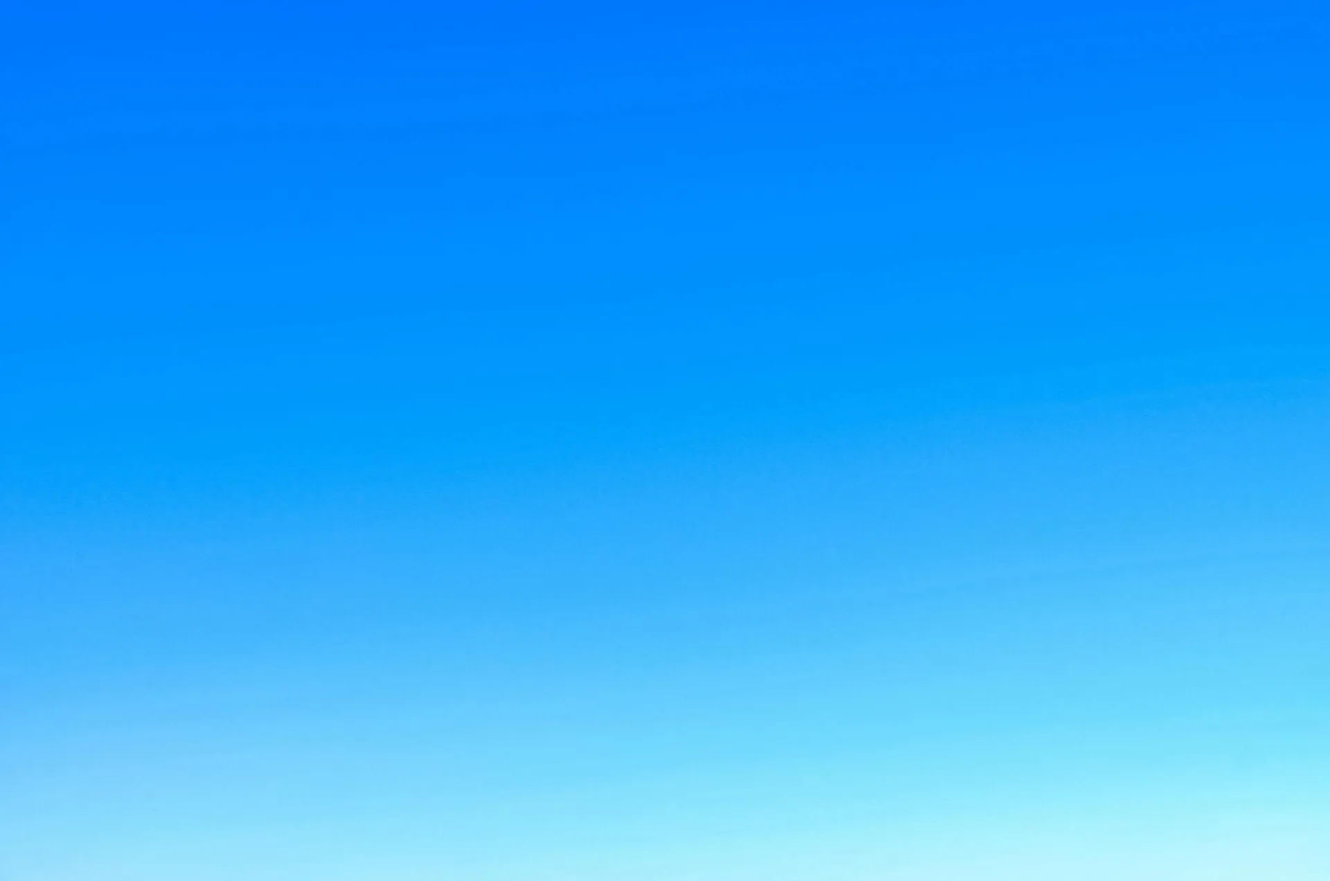 A serene view of a vibrant clear blue sky with a subtle gradient, perfect for backgrounds.