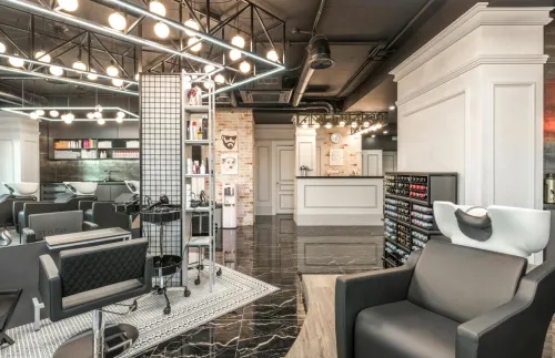Backwash chair with sink placed near shelves with cosmetology products and reception desk in stylish beauty salon with decorated walls