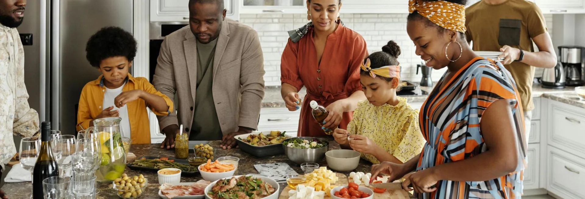 A happy family gathers in the kitchen to prepare a delicious meal together, fostering togetherness and joy.